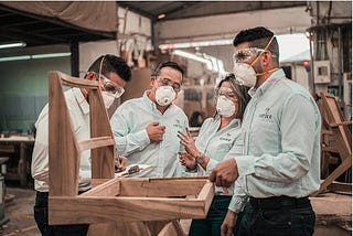 A group of people working together wearing N95 mask