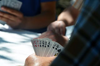 Someone holding a hand of cards.