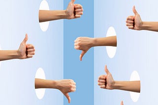 Hands with thumbs down or thumbs up sticking out of holes in two walls