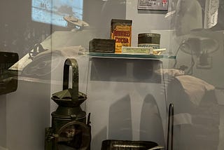 Chocolate tin box, lamp, cigarette box and lunch box displayed in the Bastogne war museum