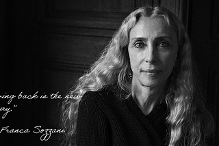 A black-and-white photograph of Franca Sozzani, with white script: “Giving back is the new luxury. —  Franca Sozzani”