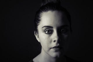 Sad woman with tear down her face