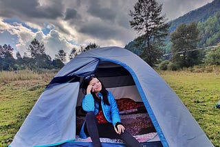 Jo camping in a blue tent