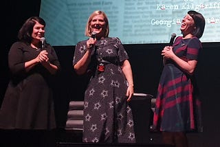 Karen Kilgariff, Olivia Standbridge and Georgia Hardstark on stage at the Hammersmith Apollo laughing.