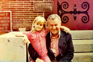 Photo of me and my dad. I’m around 8 or 9 years old. We’re sitting on church steps.