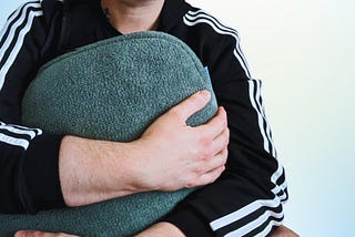 close-up of me holding a weighted pillow to my chest