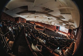 A fisheye perspective of the big auditorium — Hall 1 of the convention center in Hamburg — during the opening ceremony at CHI23.