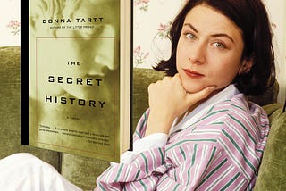 Donna Tartt lying on a couch and her book, “The Secret History”