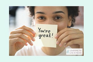 Decorative image of a woman holding a post it that says “You’re great!”.