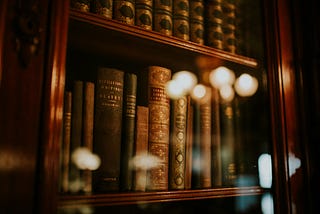 A bookshelf with hardbound books.