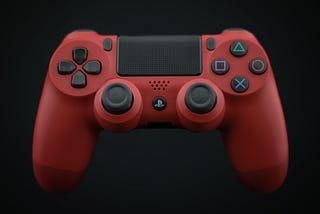 A red play station game controller against a black background