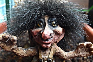 A troll sculpture with wiry hair sticking out all over.