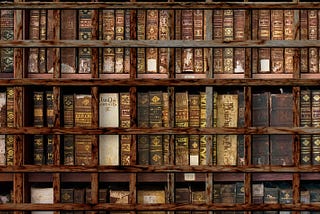 A shelf of thick scientific tomes, protected by a gridwork of foreboding, rusting bars.