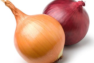 A pair of onions sitting together.
