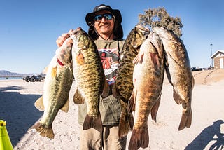 Fisherman holding fish caught in Parker, AZ and Lake Havasu, AZ