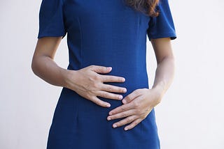 A woman holding her stomach.