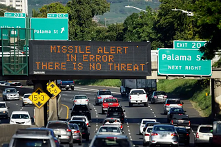 A sign in Honolulu that corrected a false alert about an incoming ballistic missile on Jan. 13, 2018. Credit: Cory Lum/Associated Press and New York Times (https://www.nytimes.com/2018/01/30/technology/fcc-hawaii-missile-alert.html)