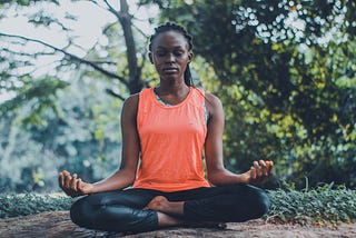 Young woman meditating outside