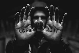 Black and white photograph of a man with hands extended palms outfront that reads “careless”