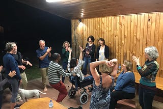 the author throws her hands in the air while surrounded by her amazing coworkers