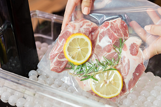 Meat and lemons being prepared using the Sous vide technique.
