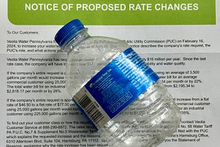 A empty water bottle and a water service rate change letter