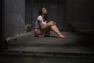 young-girl-in-white-shirt-in-concrete-room