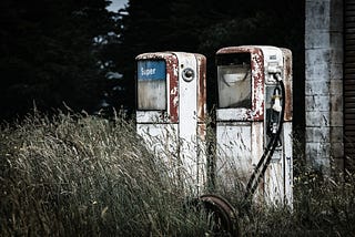 two abanoned and forlorn gasoline pumps