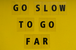 letters on yellow background saying go slow to go far