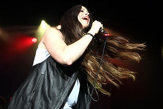 Singer-songwriter Alanis Morissette singing on stage