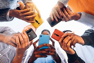 Five people using phones — group standing in circle