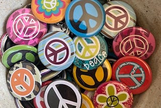 Colorful peace sign buttons to represent the peace and love logo developed in 1958.