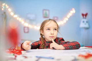 A young girl thinking of a good swear word.