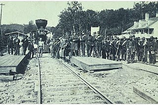 Union troops standing with a locomotive