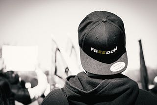 Person wearing a cap that says “freedom” in a rally in front of the White House in Washington, D.C.