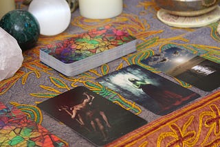 Tarot cards & mystic accoutrements set out on a table