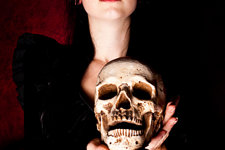 a young woman dressed in black over a red background holding a skull