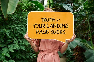 Woman holds up “your landing page sucks” sign.