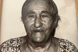 Photo of my Bubbie, hair back in a bun, old face with many lines and lots of character.