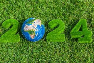 2024 numbers lying on the grass while the zero is replaced with a ball depicting the planet