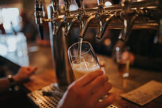 Bartender pouring a beer from a tap