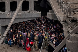 A large crowd of Ukrainians shelter underneath a damaged concrete bridge in Kyiv.