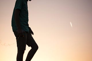 A man walking alone at sunset