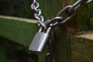 Padlock and chain securing a wooden structure