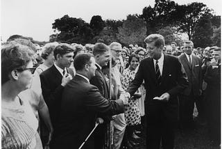 President John F. Kennedy greets Peace Corps volunteers on the South Lawn of the White House on August 9, 1962.