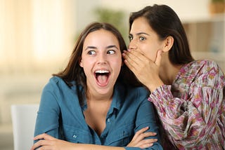 Two women gossiping.