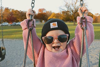 Photo of a kid with a victorious smile on her face.