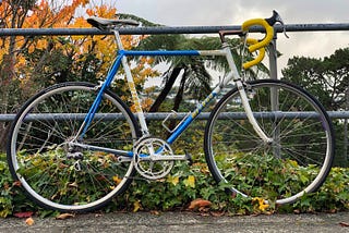 1980s steel racing bicycle leaning against a railing