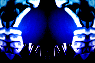 An image of a person with their finger to their lips as if they are telling someone to be quiet. The image is mirrored vertically and is different shades of blue and black.