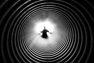 A man looking down a deep tunnel, courtesy Anthony Derosa, Pexels (211816)